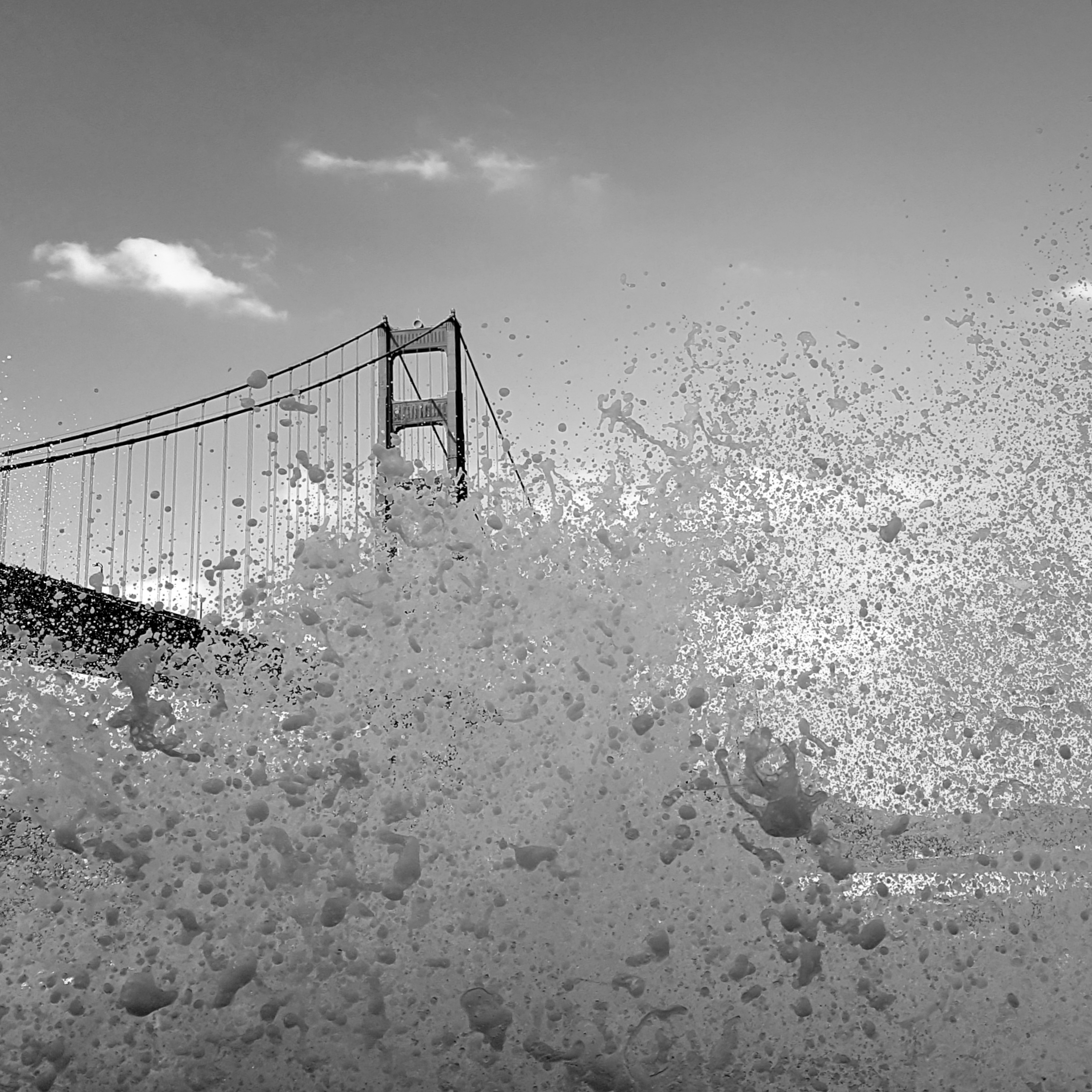 Foam rising in front of a suspension bridge